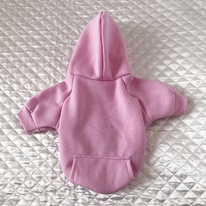 Close-up of pink pet hoodie showing soft fleece texture and functional back pocket detail