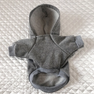 Detail of grey pet hoodie showing soft fleece lining and ribbed cuffs on white background