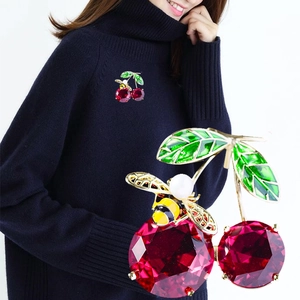 Enamel cherry and bee brooch with red gems, green leaves and a pearl on golden metal