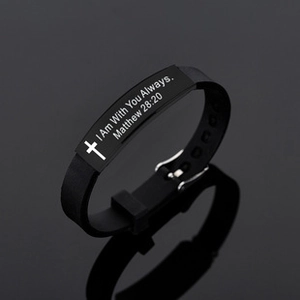 Detail of black silicone bracelet with engraved cross and bible verse on metal plate