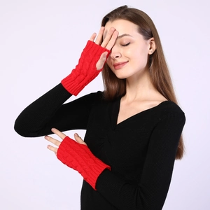 Detailed cable knit pattern on red fingerless arm warmers made of soft acrylic yarn