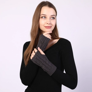 Detail of dark grey cable knit arm warmers showing thumb hole and fabric texture