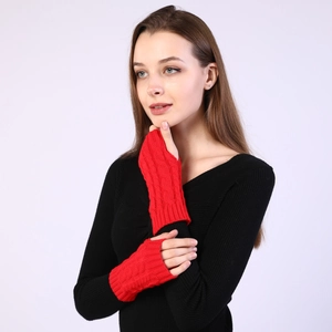 Detail of red cable knit arm warmer showing textured pattern and fingerless design