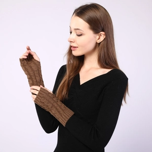 Detailed cable knit texture on brown fingerless arm warmers for autumn and winter