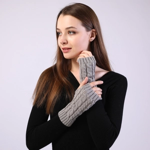 Detailed close-up of grey cable knit texture on warm fingerless arm warmer sleeves