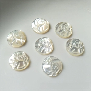 Macro detail of seven white mother of pearl angel cameo charms with iridescent luster