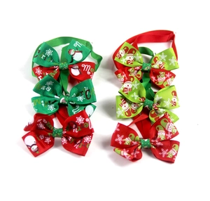 Detail view of 6 Christmas pet bowties with snowman patterns and Merry Christmas text