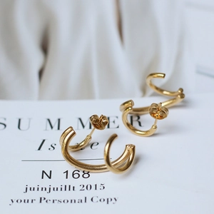 Detailed view of geometric double-hoop 18K gold-plated titanium steel earrings