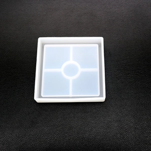 Top view of square silicone resin mold with four squares and a center round slot