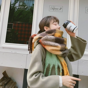 Outdoor lifestyle view of colorful plaid rainbow scarf with tassels and fringe