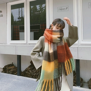 Detail of the chunky rainbow check pattern scarf with soft tassels on wool blend fabric