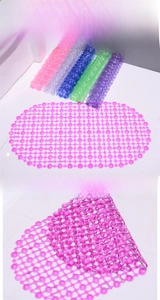 Detail of PVC bath mat featuring non-slip suction cups and drainage holes in various colors