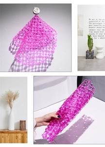 Detail of purple transparent PVC shower mat showing suction cups and flexible mesh structure
