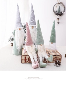 Detail of plush Christmas gnomes in Morandi colors with velvet texture and soft white beards