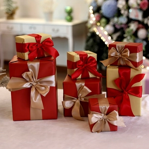 Christmas gift boxes in red and gold with silk ribbons for holiday mall window decor
