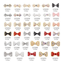 Detail view of bow nail art charms with rhinestones and pearls in various sizes