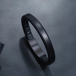 Minimalist black leather bracelet with textured band and polished dark metal clasp