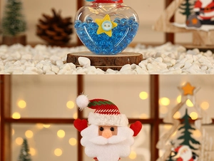 Detail of Santa Claus plush topper and heart-shaped candy jar with blue bead filling