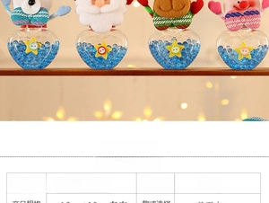 Close-up of heart-shaped Christmas candy jars with cute Santa and reindeer fabric plush lids