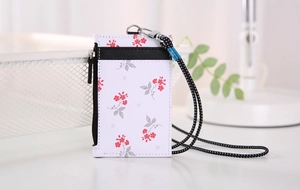 Detail of floral PU leather card holder with black zipper pocket and patterned neck lanyard