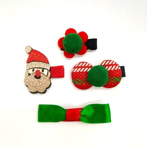 Detail view of 4-piece Christmas hair clip set with Santa Claus and festive bows