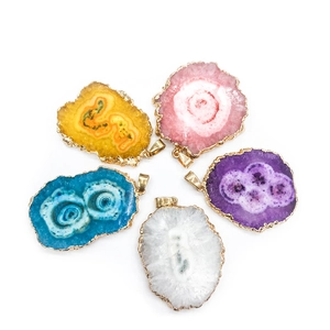 Detail of five multi-colored agate geode slice pendants with elegant gold plated edges