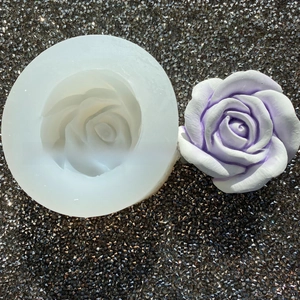 Detailed macro view of 3D rose silicone mold and finished purple plaster flower