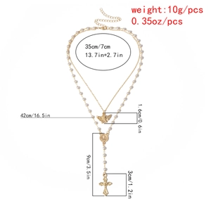 Detail view of gold layered pearl necklace with size dimensions and cross pendant specs
