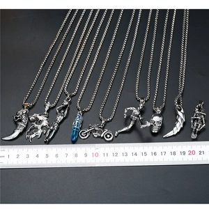 Detail view of various punk style pendants with a ruler showing the exact size and scale