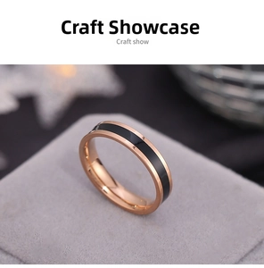 Macro detail of rose gold titanium steel ring with black enamel inlay and mirror polish