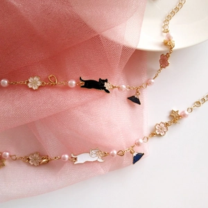 Japanese style gold charm bracelet with cherry blossom, Mount Fuji, and cute cat pendants