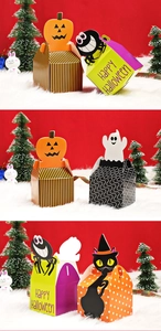 Detailed view of Halloween paper candy boxes with pumpkin and ghost themed patterns
