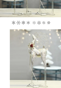 Detailed view of a glittering silver Christmas reindeer with gold antlers and festive collar