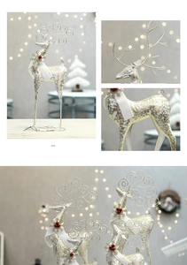 Close-up of silver glitter Christmas reindeer with metal antlers and red berry detail