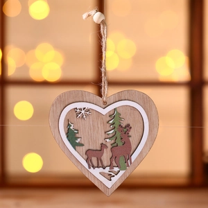 Detail of wooden heart ornament with laser-cut reindeers and trees for Christmas