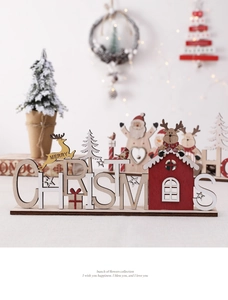 Detail of wooden Merry Christmas table decor with reindeer and Santa Claus elements