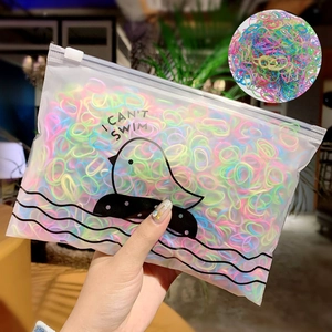 Detail of colorful elastic hair bands in a transparent matte bag with cartoon design
