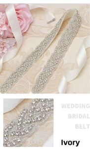 Detail of bridal belt showing shiny rhinestones on ivory ribbon for wedding dress