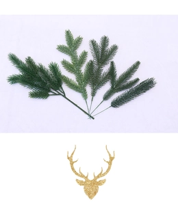Detail of green artificial pine branches and golden reindeer head DIY Christmas ornaments