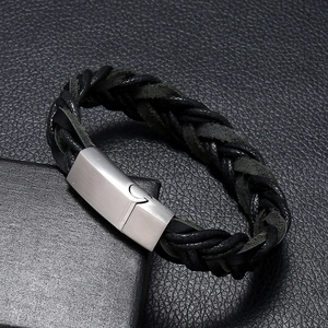 Braided black leather bracelet for men with silver magnetic clasp on leather background