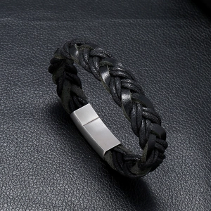 Detailed view of woven black leather bracelet with silver magnetic metal clasp