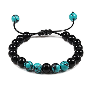 Macro view of adjustable beaded bracelet with black polished beads and turquoise stone