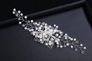 Detailed macro view of bridal headpiece featuring silver wire and hand-woven white pearls
