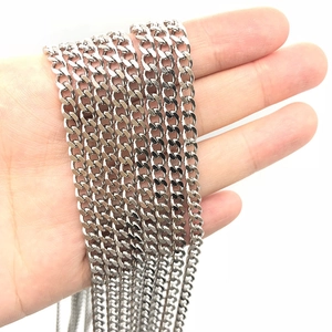 Silver stainless steel Cuban link chain necklace held by hand showing metallic texture