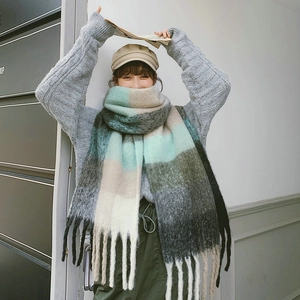 Thick colorful plaid knit scarf with tassels in blue, beige, and gray stripes