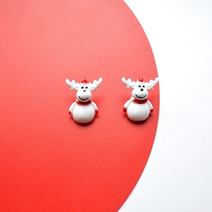 Detailed view of hand-painted white reindeer earrings with red festive hats and scarves