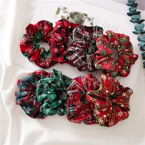 Detailed set of eight festive Christmas scrunchies in red green and plaid snowflake patterns