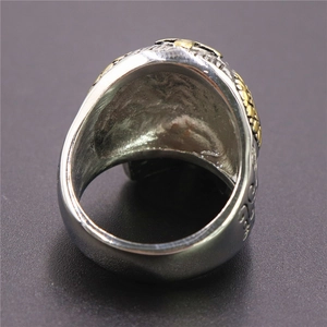 Macro shot of the polished silver and gold vintage skull ring interior and band structure