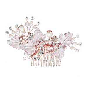 Detail of rose gold bridal hair comb with pearls, rhinestones and metal leaves