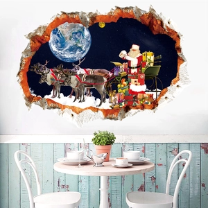 Detailed 3D Christmas wall decal of Santa flying through space on a living room wall